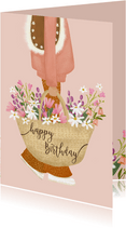 Verjaardagskaart met vrouw met mand vol kleurige bloemen