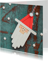 Kerstkaart met de kerstman op een blauwe deur 