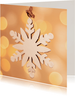 Kerstkaart met een sneeuwvlok en achtergrondverlichting