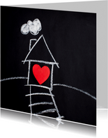 Nieuw huis kaart met wit huis en rood hart op bord