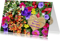 Beterschapskaart bloemenpracht in border met houten hartje