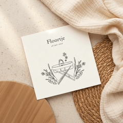 Lief zwart wit geboortekaartje met wiegje en bloemen