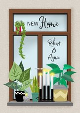 Verhuiskaart met diverse planten en kaarsen in vensterbank