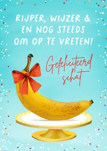 Grappige verjaardagskaart met rijpe banaan met strik