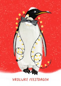 Kerstkaart met pinguïn met kerstlichtjes