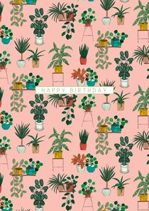 Verjaardagskaart met planten op een roze achtergrond.