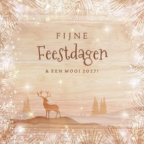 Houtlook kerstkaart met rendier in landschap en sneeuwborder