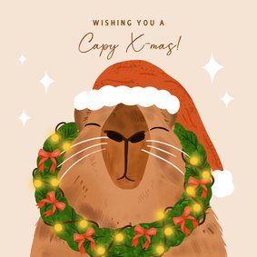 Vrolijke kerstkaart met capybara en kerstkrans