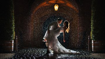 Bruidspaar danst in de regen