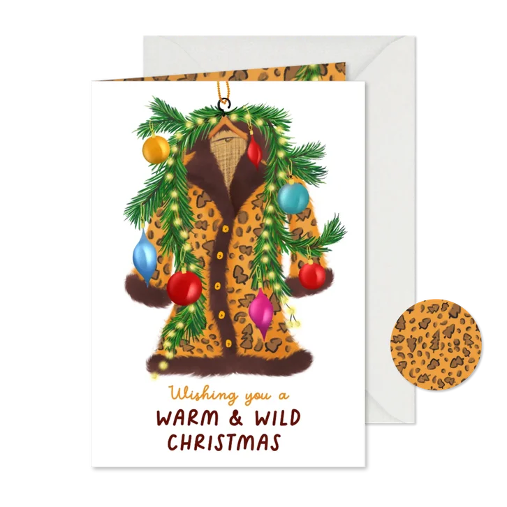 Kerstkaart met warme kerstjas en kersttakken