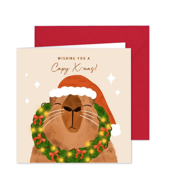 Vrolijke kerstkaart met capybara en kerstkrans