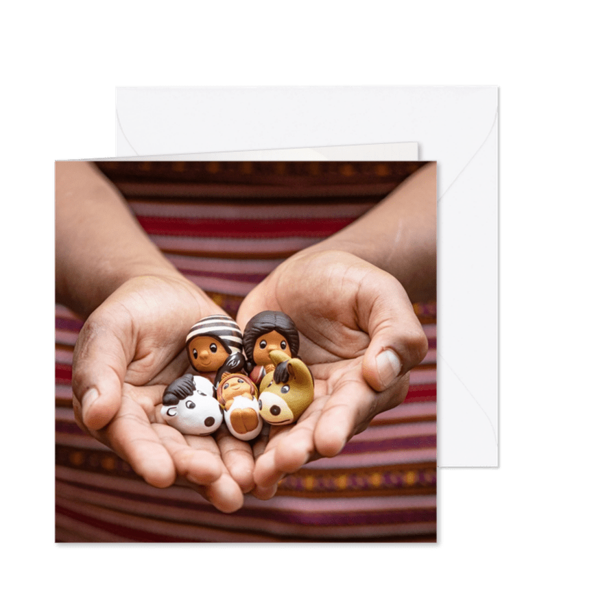 Kerstkaart met twee handen die een kerstgroep vasthouden - Kaartimpressie